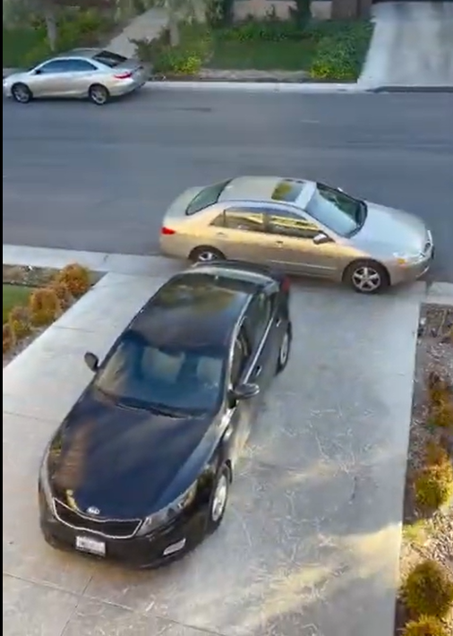 Illegally parked car blocking a driveway