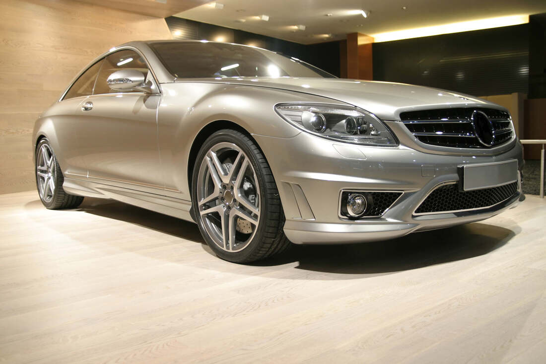 Silver Mercedes Benz luxury car in showroom